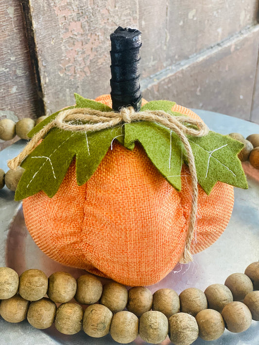 This BURLAP FELT PUMPKIN is made of a special blend of felt and foam, resulting in a pumpkin that's both soft and sturdy. Measuring 6.5X6X6, it's the perfect size for adding a touch of whimsy to your fall decor.